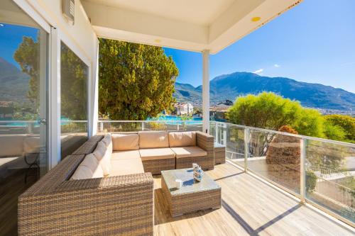 a living room with a couch and a balcony at Residence Villa 1 in Oludeniz