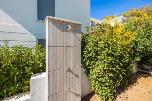 a wooden door in front of a bush at Residence Villa 1 in Oludeniz