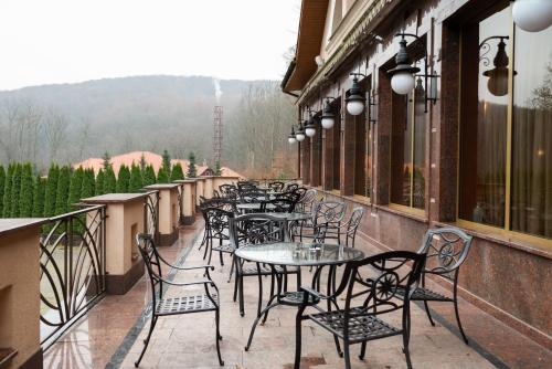 a row of tables and chairs on a balcony at Solva Resort Medical & SPA in Polyana