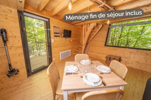- une salle à manger avec une table dans une petite maison dans l'établissement Cabane insolite dans les cevennes - les sous-bois de la bastide, à La Bastide-Puylaurent