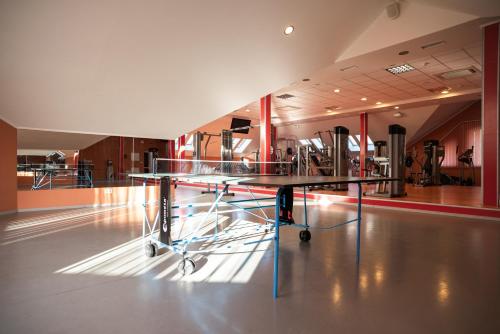 a gym with a table in the middle of a room at Solva Resort Medical & SPA in Polyana