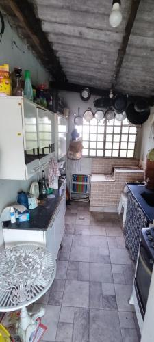 a kitchen with a counter and a stove in it at Chácara 2 Marias in Novo Gama