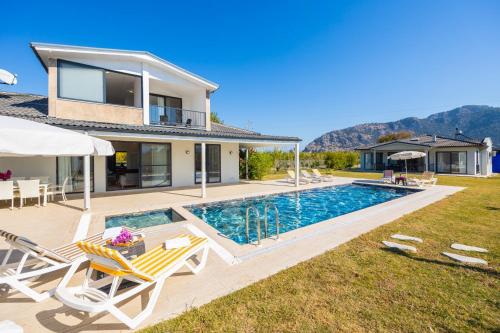 a villa with a swimming pool and a house at Villa Funda in Dalyan