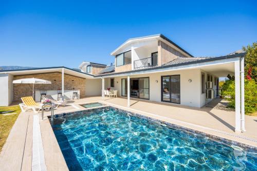 a home with a swimming pool in front of a house at Villa Funda in Dalyan
