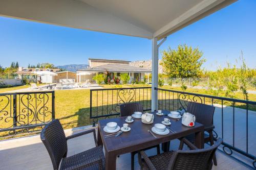 a table and chairs on a balcony with a view at Villa Funda in Dalyan