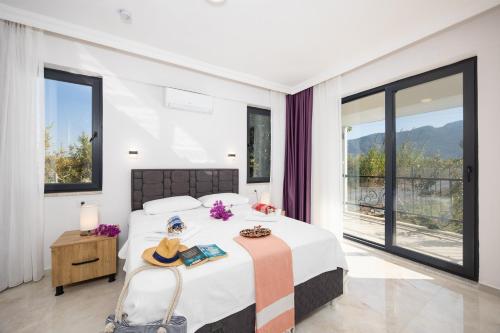 a bedroom with a bed and a large window at Villa Funda in Dalyan