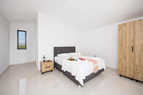 a bedroom with a large bed and a wooden cabinet at Villa Funda in Dalyan