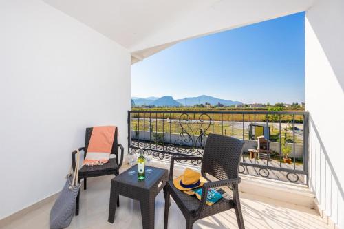 a balcony with two chairs and a table with a view at Villa Funda in Dalyan