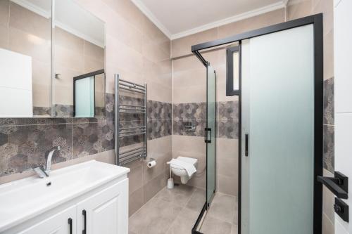 a bathroom with a toilet and a sink and a shower at Villa Funda in Dalyan