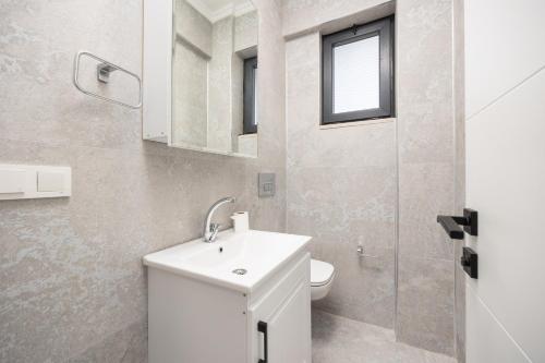 a bathroom with a white sink and a toilet at Villa Funda in Dalyan