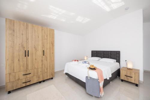a bedroom with a bed and wooden cabinets at Villa Tolga in Dalyan