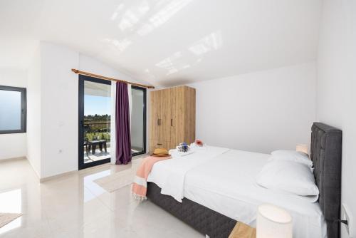 a bedroom with a large bed and a large window at Villa Tolga in Dalyan
