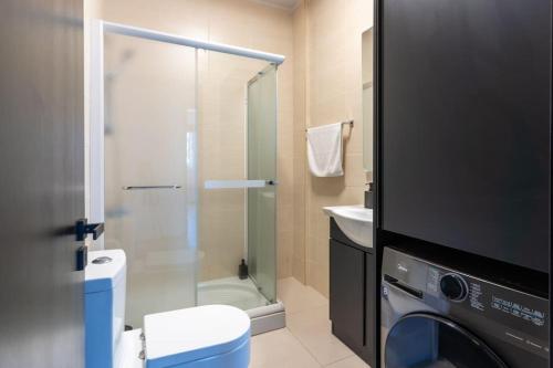 a bathroom with a shower and a washing machine at The Penthouse - 3BR Seaview with Private Pool in Larnaca in Larnaca