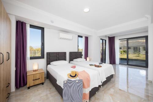 a bedroom with a large bed with purple curtains at Villa Tolga in Dalyan