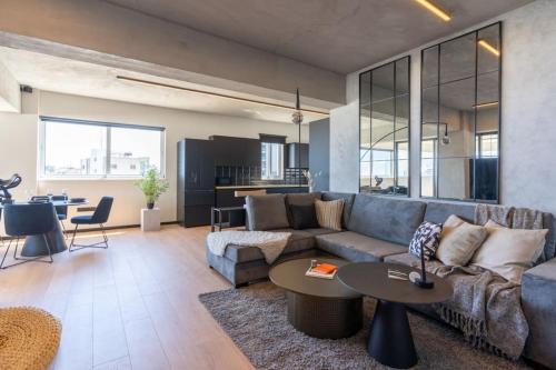 a living room with a couch and a table at The Penthouse - 3BR Seaview with Private Pool in Larnaca in Larnaca