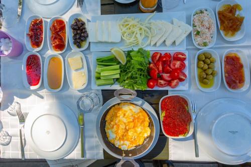 a table filled with different types of food on plates at Villa Tolga in Dalyan