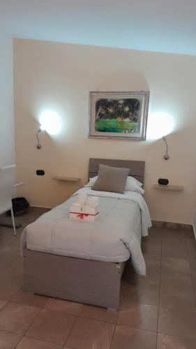 a bedroom with a bed with two candles on it at Rainbow Sweet Rooms in Valmontone