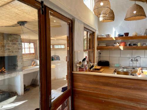 a kitchen with a wooden door and a counter at UnderHill Farm in Klipkraal