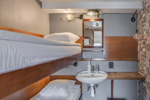 a bathroom with two bunk beds and a sink at Rygerfjord Hotel & Hostel in Stockholm
