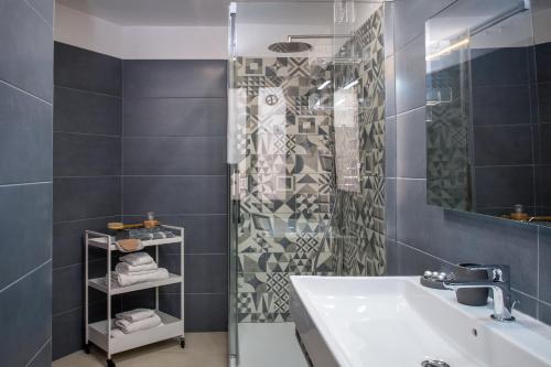 a bathroom with a sink and a shower at RomAntica Bocca della Verità in Rome