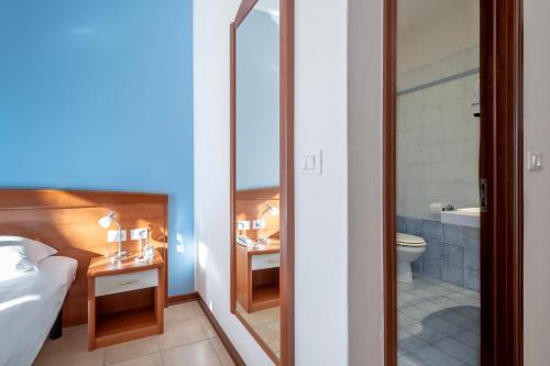Postel nebo postele na pokoji v ubytování Hotel Caracas