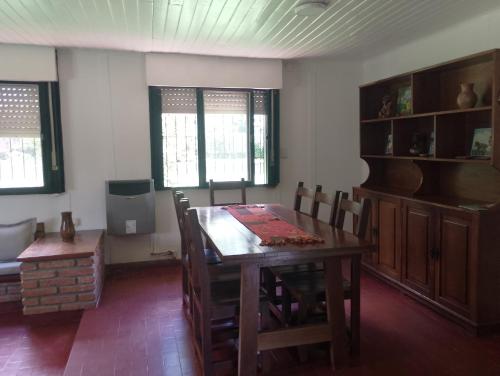 a dining room with a wooden table and chairs at Bayas Coloradas, San Lorenzo, Salta in San Lorenzo