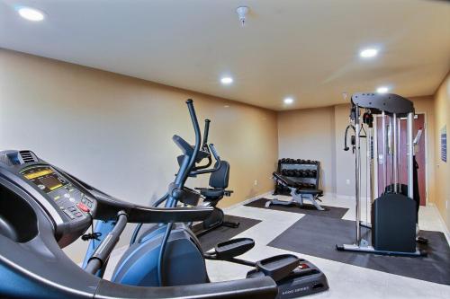 a gym with two treadmills and two exercise bikes at Cobblestone Hotel & Suites - McCook in McCook