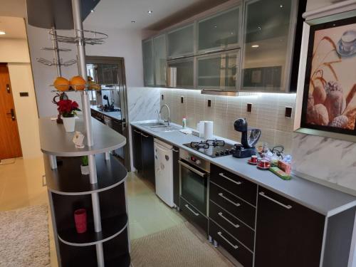 a kitchen with a sink and a stove at Garsoniera Craiova Centru in Craiova