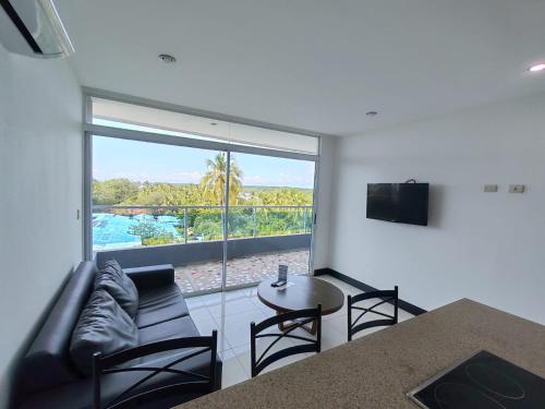 a living room with a couch and a table at Puerto Azul Residences in Puntarenas