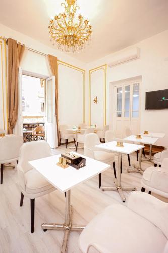 a room with tables and chairs and a chandelier at Downtown Antique Hotel in Cairo