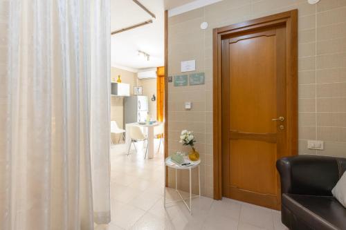 a living room with a couch and a door at Ice Apartment - Free Wifi & Parking in Quartu SantʼElena