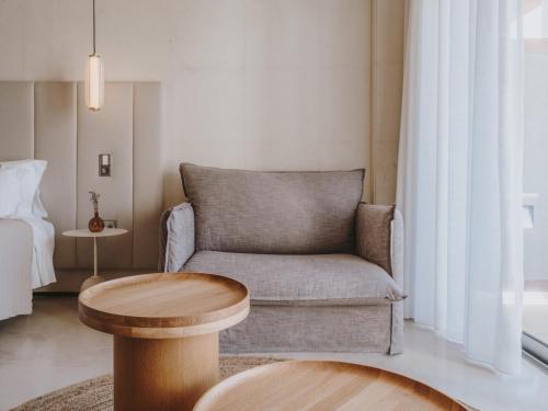 a living room with a couch and a table at Aguas de Ibiza Grand Luxe Hotel - Small Luxury Hotel of the World in Santa Eularia des Riu