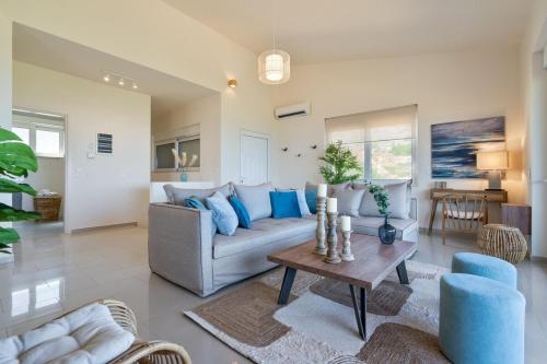 a living room with a couch and a table at Villa Marathi with stunning ocean view in Chania Town