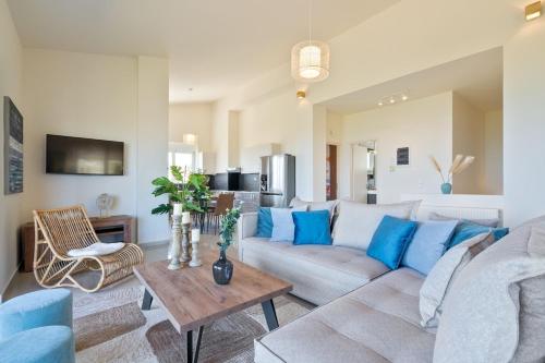 a living room with a couch and a table at Villa Marathi with stunning ocean view in Chania Town