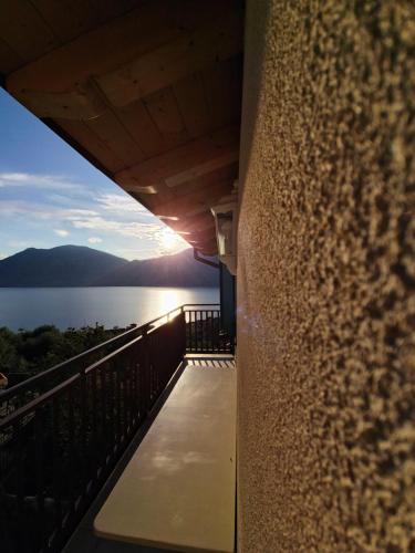 a balcony of a house with a view of the water at Casa antico borgo - appartamento 3 in Brenzone sul Garda