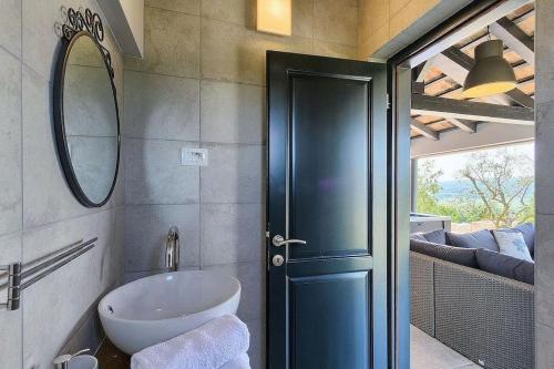 a bathroom with a sink and a mirror at Villa Analucija I by Istrialux in Potpićan