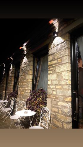 two chairs and a table in front of a building at Gogo Moustache Guest House in Përmet