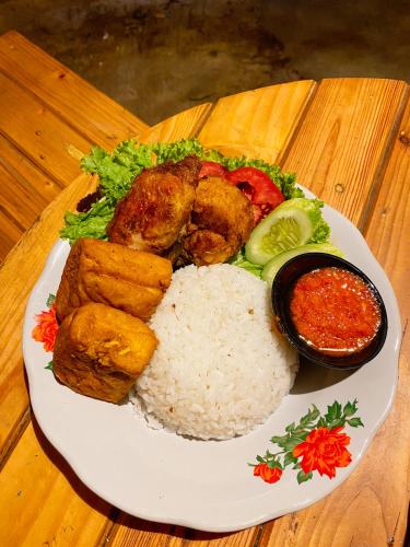 a plate of food with rice and meat and vegetables at Seribu Pulau Pangalengan in Citere