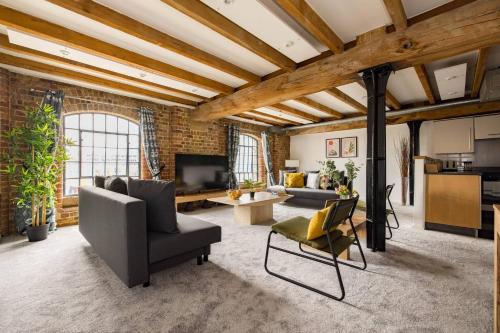 a living room with a brick wall at Wild Roses Serviced Apartments - ExCel Warehouse 2 in London