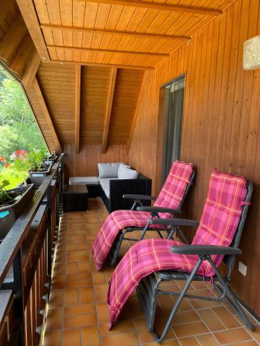 a porch with two chairs and a couch at Hugenhof in Kirchzarten