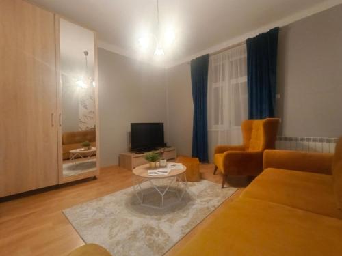 a living room with a couch and a table at House in the City Center 1 piętro in Przemyśl