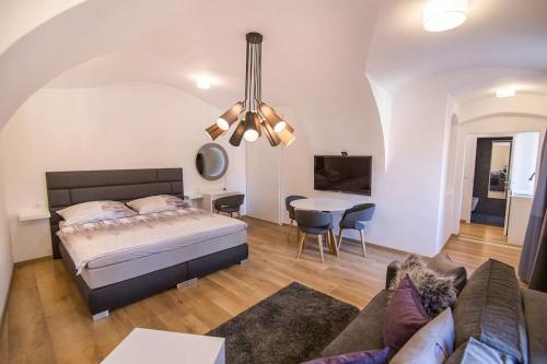 a bedroom with a bed and a living room at Studio Arco Rustic in Zagreb