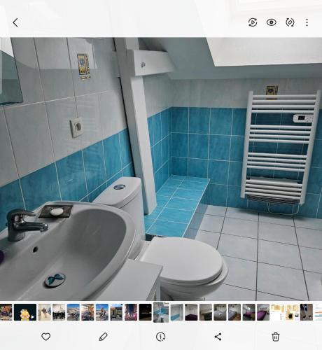 une salle de bain avec des toilettes blanches et un lavabo dans l'établissement Les 6 chemins, à Saint-Nazaire