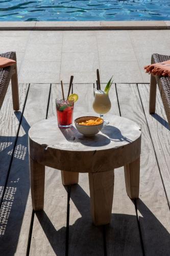 a table with a bowl of food and two drinks on it at Résidence U Frusteru in Propriano