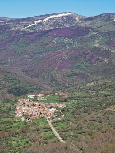 a small town in the middle of a mountain at Hostal Cholo in Brañosera