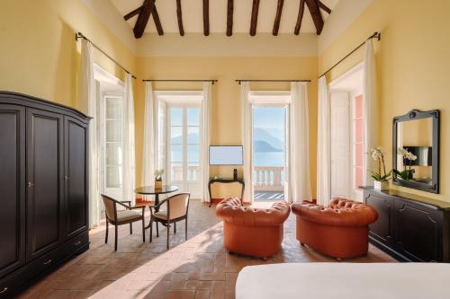 a living room with a table and chairs at Hotel Royal Victoria, by R Collection Hotels in Varenna