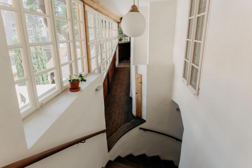 a staircase in a house with windows at Klášterní apartmány in Český Krumlov