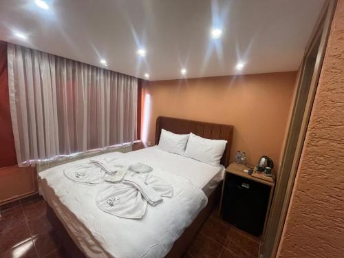a hotel room with a bed with towels on it at Cemre Homes in Istanbul