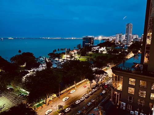 a view of a city at night with the water at 10pax 3-Bedroom l Seaview l Georgetown l Gleneagles l Mansion One in George Town
