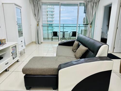 a living room with a couch and a view of the ocean at 10pax 3-Bedroom l Seaview l Georgetown l Gleneagles l Mansion One in George Town
